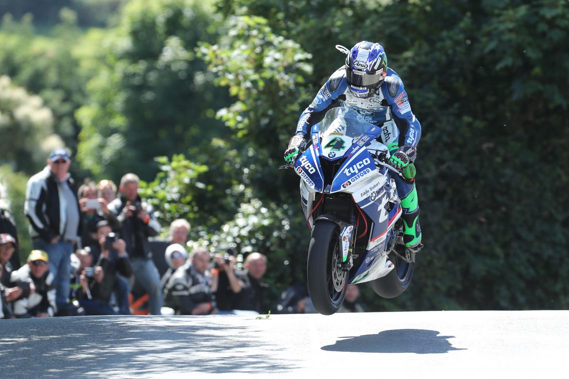 Leap of faith. Ian Hutchinson makes short work of the hair-raising S-bend at Ballaugh Bridge.